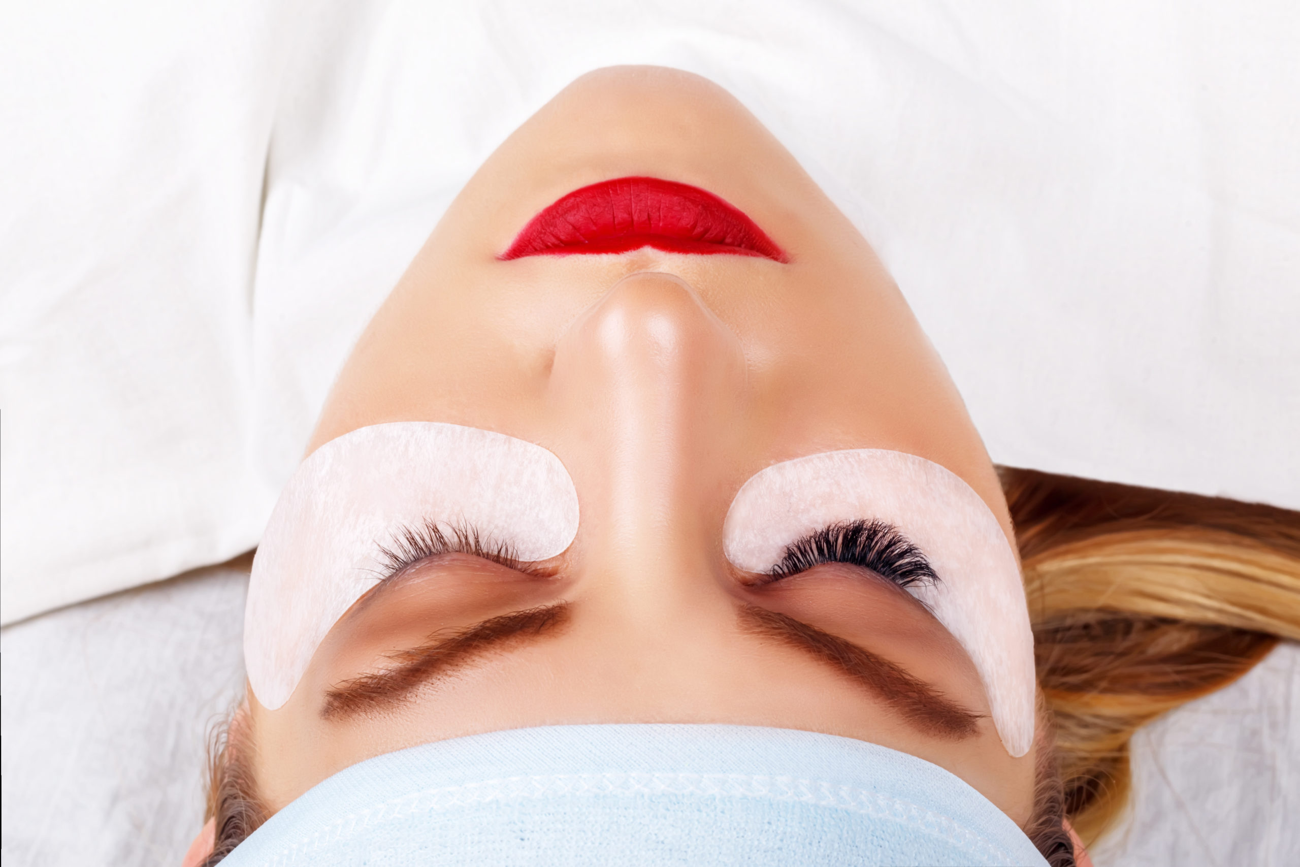 Eyelash Extension Procedure. Woman Eye with Long Eyelashes. Lashes. Close up, selected focus.