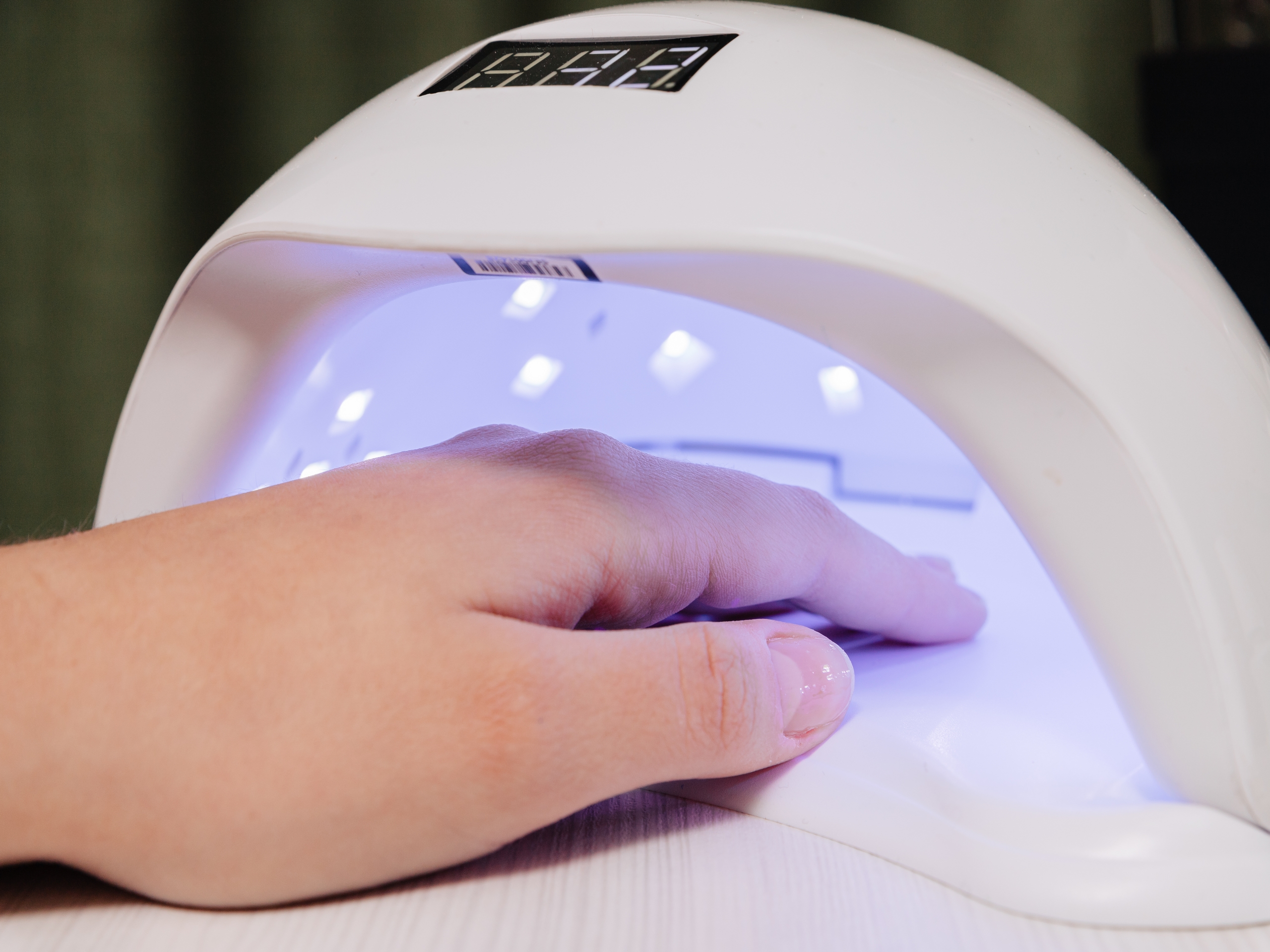 Manicure process. Drying nails in a device with ultraviolet lamps.